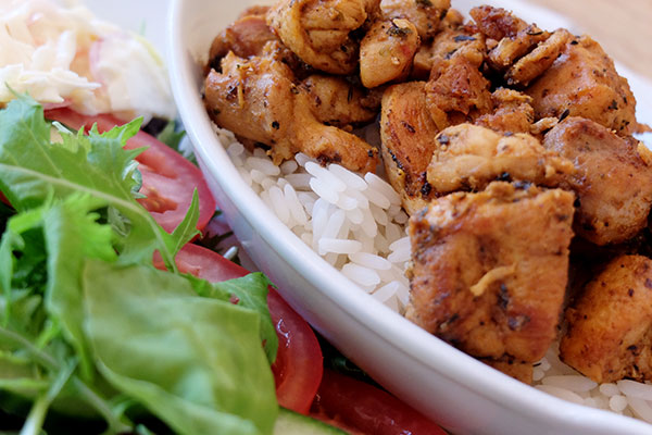 A photo of grilled chicken and rice